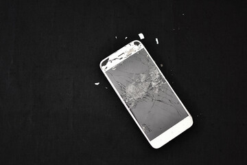 broken phone on dark background