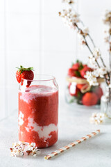 strawberry smoothie with flowers on a white background