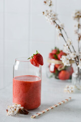 strawberry smoothie with flowers on a white background
