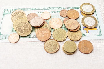 Belarusian coins and hundred dollars USA, closeup, cropped image, toned