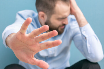 Crying man, bearded man with depression, a focus on the hand of a man, cropped image, close-up
