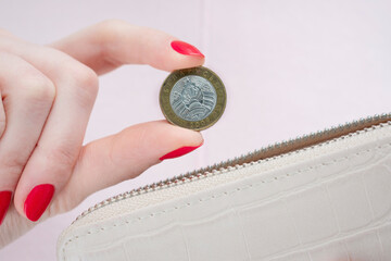 Woman's hand with belarusian coins, closeup, cropped image, poverty concept