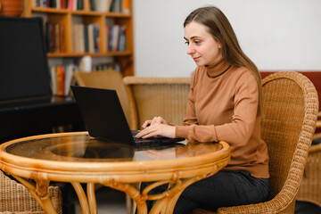 young beautiful european girl work in cafe on a laptop