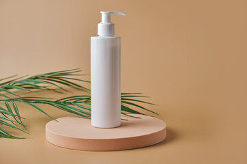 Trendy cosmetics tube on pedestal at the pink background.