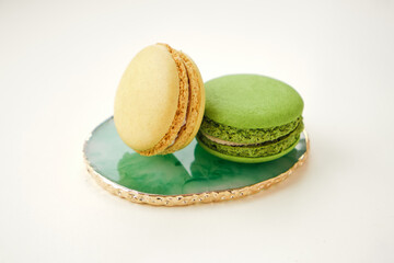 macaroon on the original marble green plate on beige background