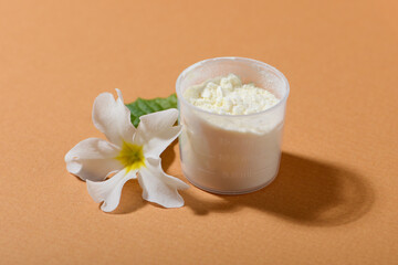 Dried Royal jelly powder on orange background.