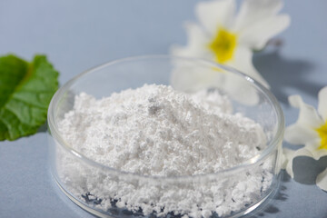 Allantoin powder on blue background. Close up.