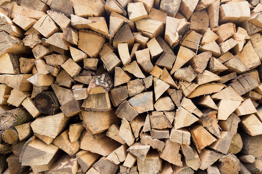 There was a pile of chopped firewood. Folded dry logs of firewood close up. Firewood for winter heating in the countryside