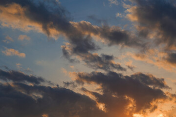 Evening sunset, sky above the clouds with dramatic yellow light.