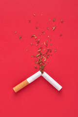 A broken cigarette and tobacco splash for quit smoking concept.