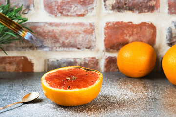 Cooking a delicious vegetarian dessert - baked or caramelized grapefruit with a cooking gas burner....
