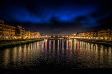 Reflection in the water of the Arno River in Florence, Italy, at night