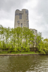 Residential buildings on the banks of Moskva River on a cloudy day. Housing construction according to the city renovation program. Moscow, Russia