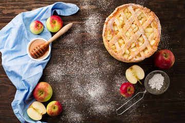 Homemade autumn apple pie on rustic wooden background.