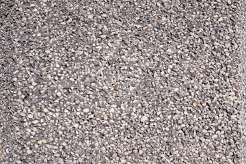 Gravel in cement on a decorative wall as background. Granular granite surface