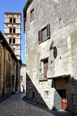 Sermoneta, Italy, 05/10/2021. A street between old medieval stone buildings in the historic town.