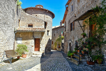Sermoneta, Italy, 05/10/2021. A street between old medieval stone buildings in the historic town.