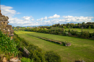 Panorama from the top of the Circus of Maxentius in a beautiful spring day with blue sky and clouds, in the distance the Castelli Romani, Rome, Appia Antica, Italy.