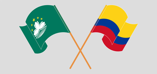 Crossed and waving flags of Macau and Colombia.