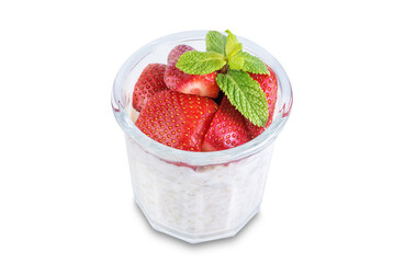 Oatmeal porridge with milk and fresh strawberries in a glass on a white isolated background