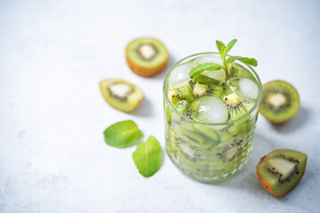 Kiwi margaritas cocktail in a glass with mint leaves