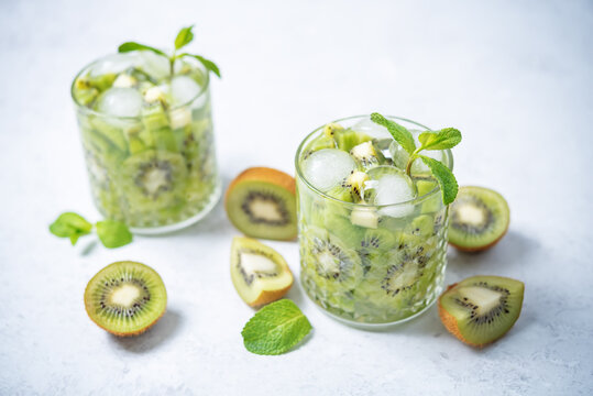 Kiwi margaritas cocktail in a glass with mint leaves