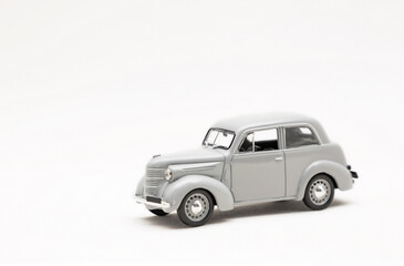 Miniature model of a retro car on a white background. A toy car model. Vintage car model.	
