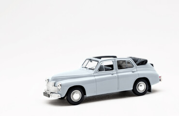 Miniature model of a retro car on a white background. A toy car model. Vintage car model.