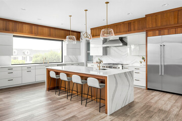 Beautiful kitchen in new luxury home with large waterfall island, gorgeous backsplash and cabinets.   - Powered by Adobe