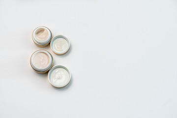 face cream in gold colour on white background