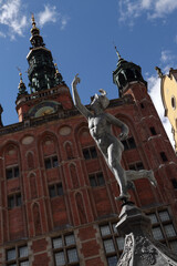 Gothic and renaissance art in Gdansk, Poland. Statue of Hermes, the idol of trade and business. Main Old Town Hall in the background.