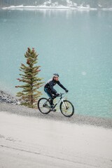 cyclist riding above glacier lake