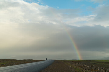 the beginning of a rainbow on a beautiful mountain sunny landscape