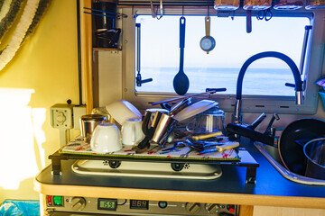 Caravan inside, clean dishes drying in kitchen