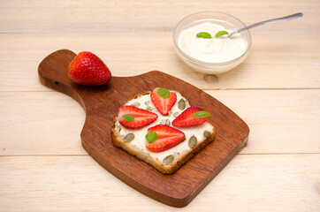 vegetarian sweet toast with cheese and strawberries and cream on the table