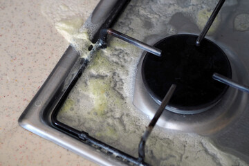 milk overflowed on the cooking stove and it got dirty,