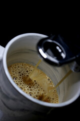 cup of fresh coffee in the coffee machine 