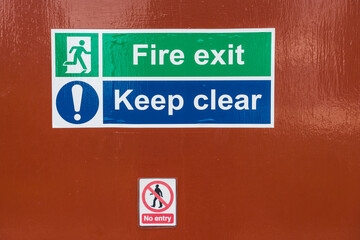 Obraz premium fire exit sign on a industrial door