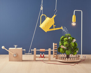 A CLOCKWORK POWERED MAGIC MONEY TREE WITH WATERING CAN AND LIGHT 