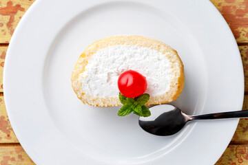 Cream sponge cake with icing and mint