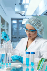 Pharma female tech works in laboratory. Caucasian, european woman, young adult in protective...