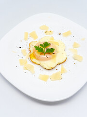 flower head shape cooked egg served with cheese flakes on top