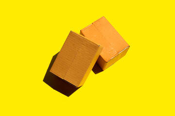 Brown cardboard box on yellow background.