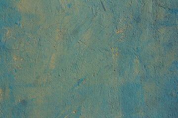 Blue painted over yellow background wall, textured surface