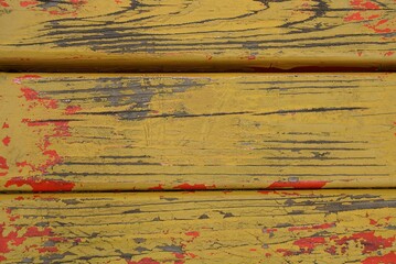 wooden texture from old shabby planks in the wall in yellow red paint