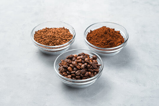 Grain, ground and granulated coffee on a gray background with space to copy.