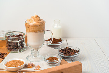 Korean invigorating drink with whipped coffee foam and milk on a white background.