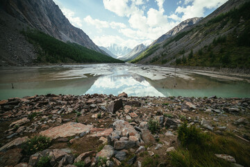 Scenic alpine landscape with beautiful shallow mountain lake with streams in highland valley from...