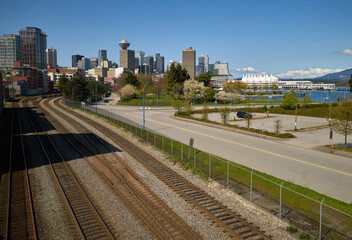 Fototapeta premium Rail Yard and Vancouver Skyline. Railroad tracks running near the waterfront in downtown Vancouver.
