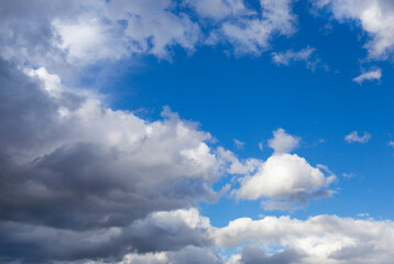 white-gray clouds fly across the blue sky. Texture of clouds and sky